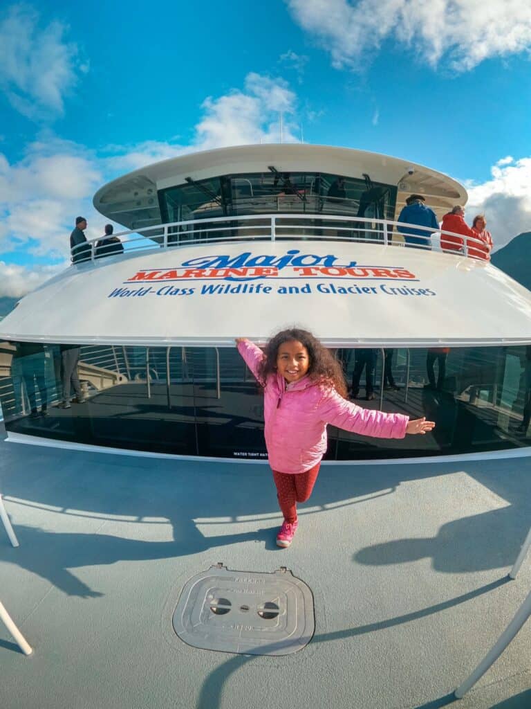 girl standing on the front of the Major Marine Tours cruise ship